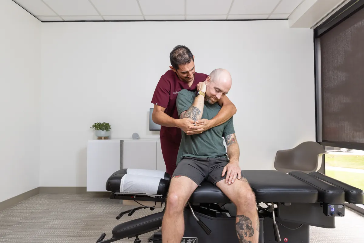 Dr. Brandon Fein performing a seated upper back chiropractic adjustment at TruSpine San Francisco