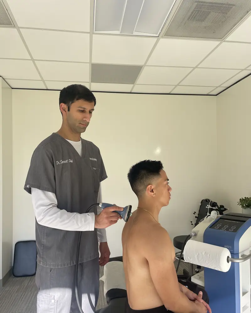 Focused Piezowave shockwave therapy on a patient's neck and shoulder at Truspine San Francisco